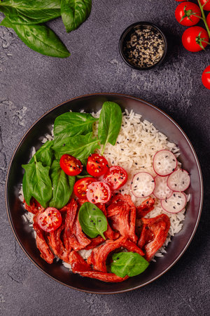Bowl with vegan fried meat substitute and vegetables served with boiled rice. Delicious healthy diet food.の写真素材