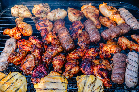 Different types of grilled meat on charcoal grill.の写真素材