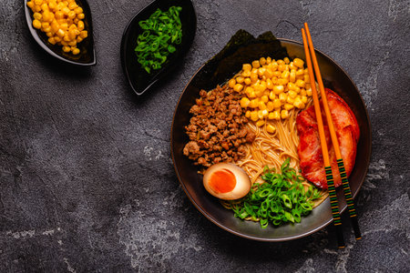 A bowl of ramen with noodles, meat and green onions, top view.の写真素材