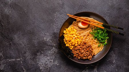 A bowl of ramen with noodles, meat and green onions, top view.の写真素材