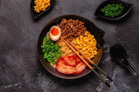 A bowl of ramen with noodles, meat and green onions, top view.の写真素材