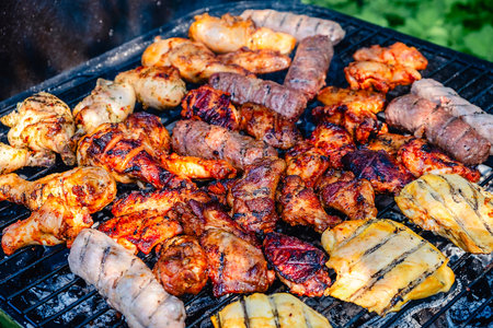 Different types of grilled meat on charcoal grill.の写真素材