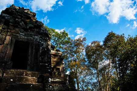 Historic building in Angkor wat Thom Cambodia with devatas carvings stone faces serenity milk oceanの写真素材