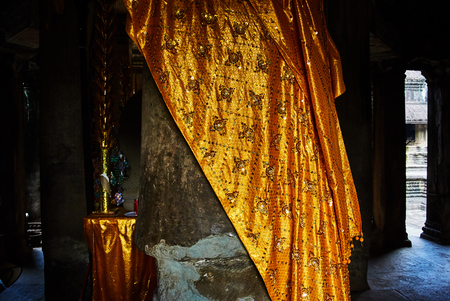 Historic building in Angkor wat Thom Cambodia with devatas carvings stone faces serenity milk oceanの写真素材