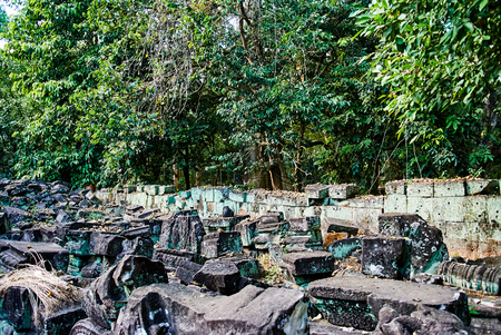 Historic building in Angkor wat Thom Cambodia with devatas carvings stone faces serenity milk oceanの写真素材