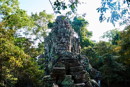 Historic building in Angkor wat Thom Cambodia with devatas carvings stone faces serenity milk oceanの写真素材