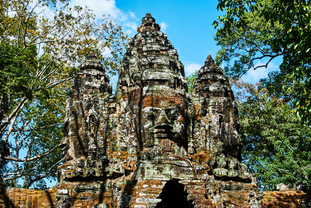 Historic building in Angkor wat Thom Cambodia with devatas carvings stone faces serenity milk oceanの写真素材