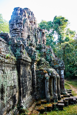Historic building in Angkor wat Thom Cambodia with devatas carvings stone faces serenity milk oceanの写真素材