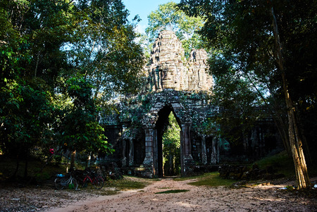 Historic building in Angkor wat Thom Cambodia with devatas carvings stone faces serenity milk oceanの写真素材
