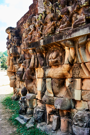 Historic building in Angkor wat Thom Cambodia with devatas carvings stone faces serenity milk oceanの写真素材