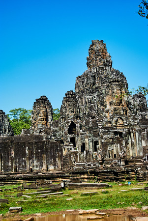 Historic building in Angkor wat Thom Cambodia with devatas carvings stone faces serenity milk oceanの写真素材