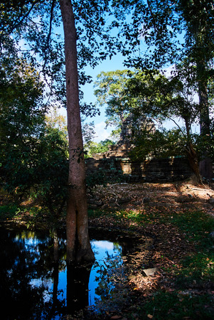 Historic building in Angkor wat Thom Cambodia with devatas carvings stone faces serenity milk oceanの写真素材