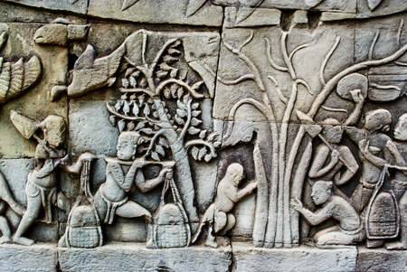 Historic building in Angkor wat Thom Cambodia with devatas carvings stone faces serenity milk oceanの写真素材
