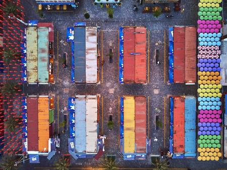 Aerial view at dawn sunset from drone bird eye eagle Angkor container night market in Siem-REap,...
