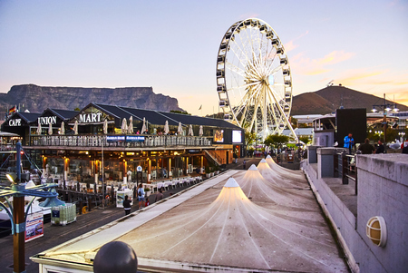 The Victoria & Alfred (V&A) Waterfront in Cape Town is situated on the Atlantic shore, Table Bay Harbour, the City of Cape Town and Table Mountain. Adrian van der Vyver designed the complex. Prince Alfred, second son of Queen Victoria, visited the Cape Coのeditorial素材