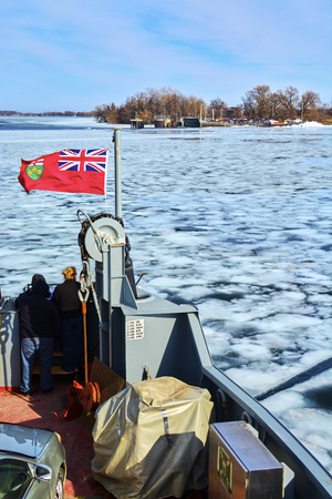 Views of Kingston frozen lake, Canada during snow storm in winter during daytimeの写真素材