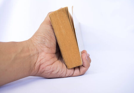 one hand holding the book