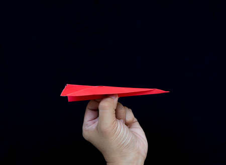 red paper plane on black backgroundの写真素材