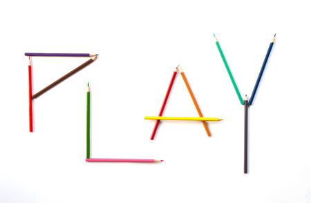 kid play color pencil as letter PLAYの写真素材