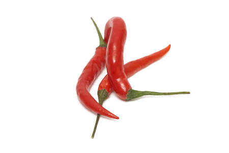 A group of Thai peppers laying and sitting over each other, isolated on white.