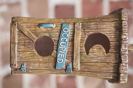 Cute birdhouse labeled occupiedの写真素材