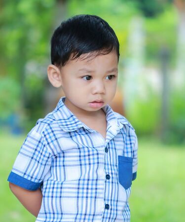 The boy standing eyes staring ahead.の写真素材