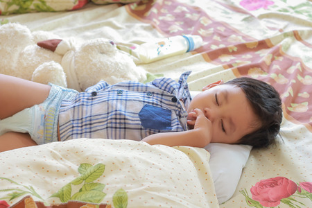 little boy sleeping in his bed.