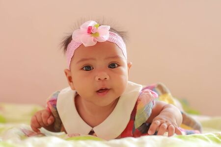 Cute little baby girl looking into the camera.