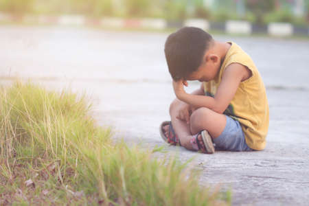 The boy sat sadly in a soft atmosphere.の写真素材