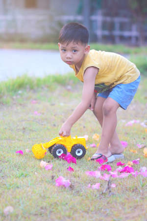 Happy boys playing in the lawn. in  bright soft atmosphere.の写真素材