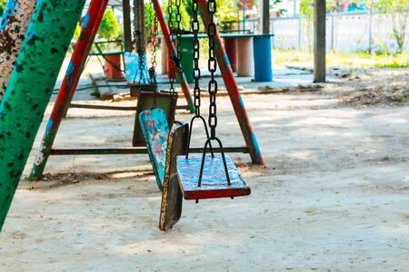 Broken chain swing playground in school.の写真素材