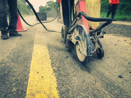 Cutting asphalt road for repair.の写真素材