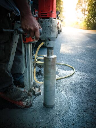 Inspection of thickness measurement of asphalt road.の写真素材