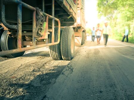 Overweight trucks cause road damage.の写真素材