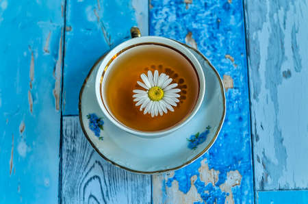 Chamomile tea on a blue backgroundの写真素材