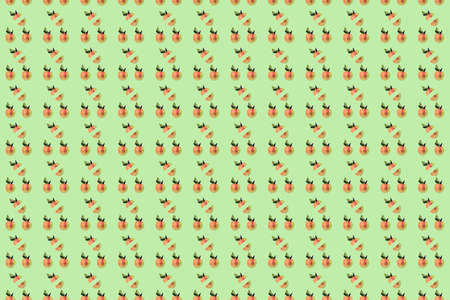 Fresh apple with red color isolated on green background. Top view. Pattern.の写真素材