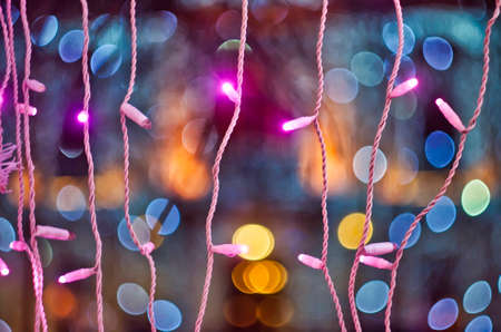Chrismas pink lights on colored background with bokeh