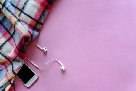 Cozy still life with plaid and gadgets on pink backgroundの写真素材
