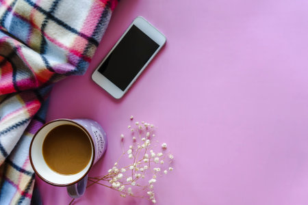 Coffee, plaid, gypsophila, smartfone on pink background.の写真素材