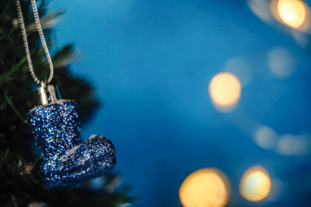 Greeting card with blue Christmas toy on blue background and bokehの写真素材