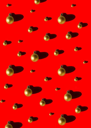 Golden Christmas balls on red backgroundの写真素材