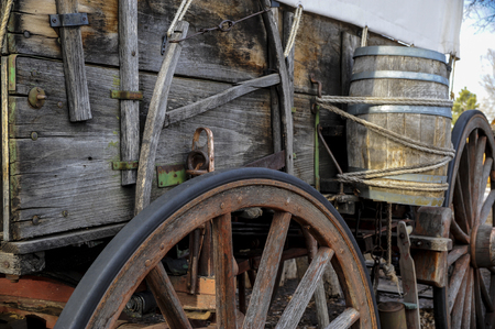 Side view of pioneer wagon with water barrel  and wheelの写真素材