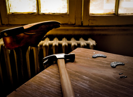Cobblers Workbench with Hammer and Shoe by Windowの写真素材