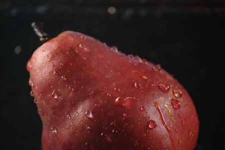 Bright red pear being washedの写真素材