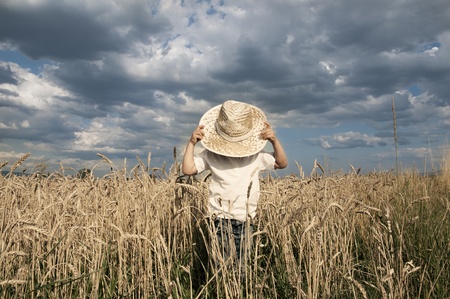 Boy in a whet fieldの写真素材