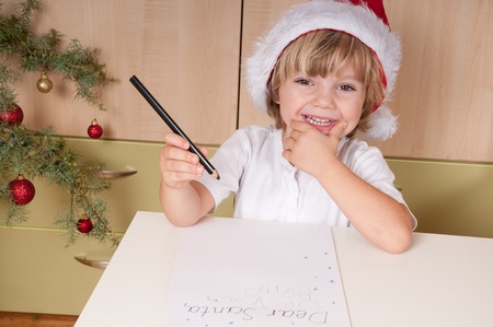 Blond boy writes a letter to Santaの写真素材