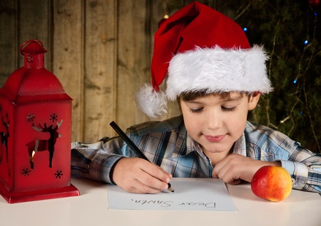 A boy writes a letter to Santaの写真素材