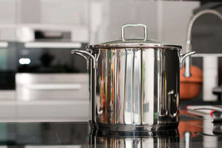 Steel pan on a hot plate in the kitchenの写真素材