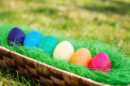 Easter eggs in a wooden basket in the garden