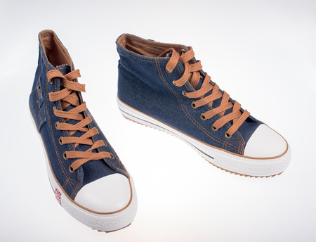 Sneakers made of denim on a white backgroundの写真素材